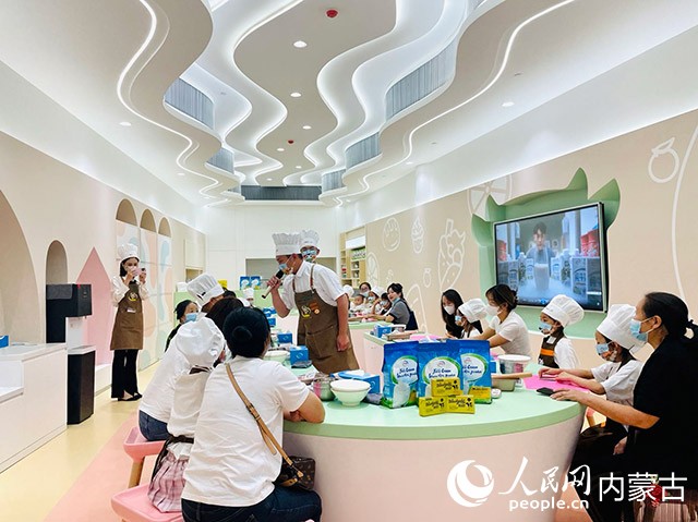 幼龄儿童正在伊利现代智慧健康谷智造体验中心体验烘焙课程。人民网 寇雅楠摄